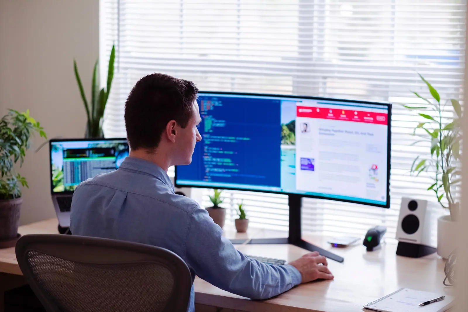 Developer working at a desk with two monitors
